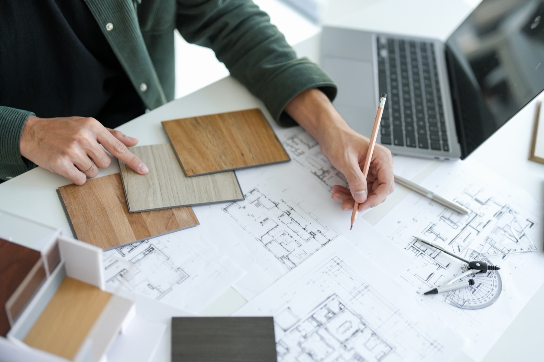 Interior designer coordinating drawings and material samples