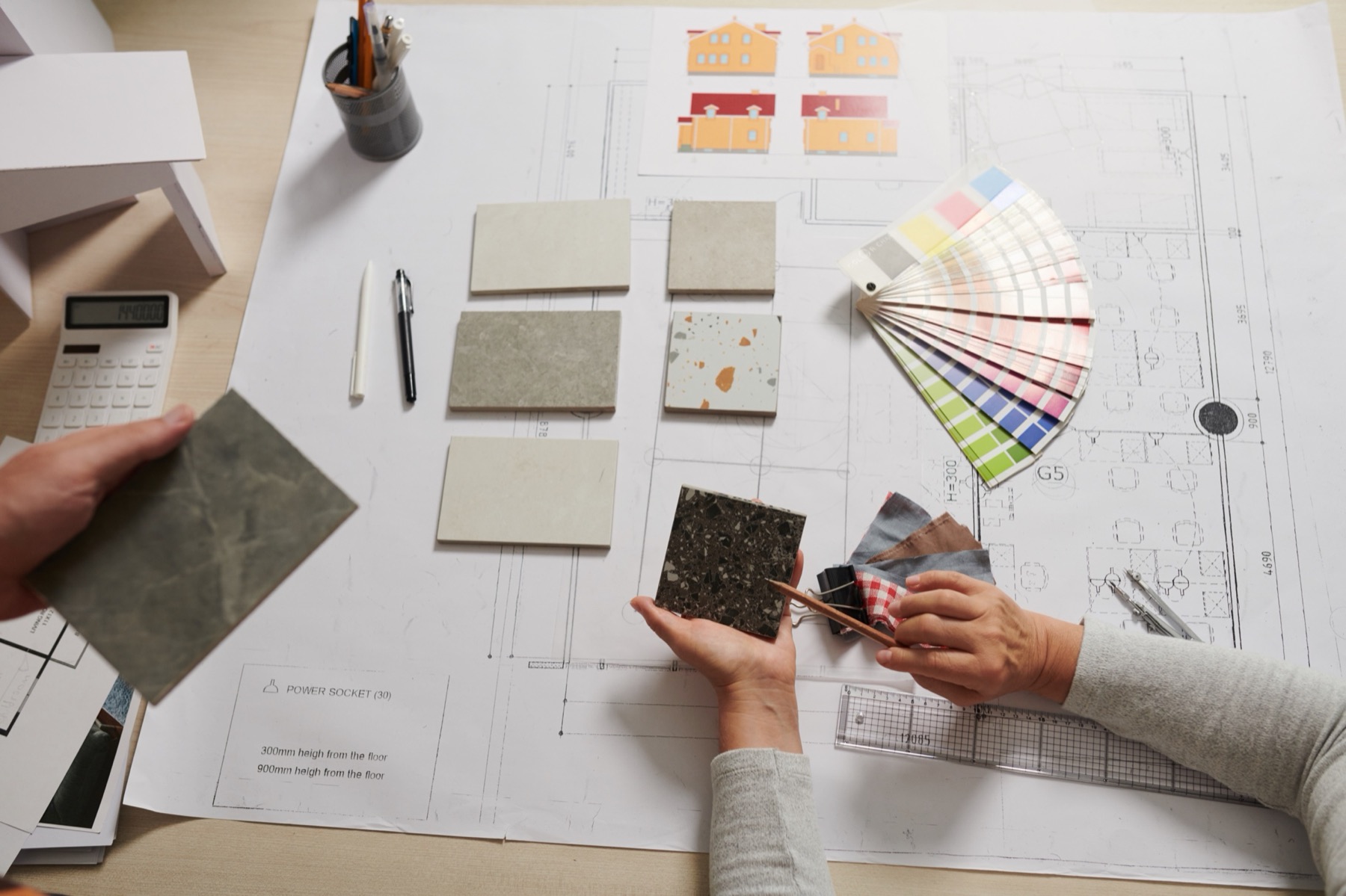 Design team reviewing drawings and material samples