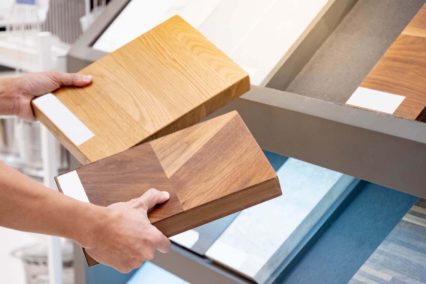 Wall finish samples being compared by hand